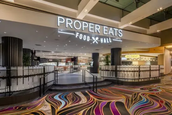Entrada de Proper Eats Food Hall dentro de ARIA · foto de prensa sin fecha indicada; los mostradores y su oferta pueden cambiar.