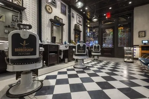 Área de barbería de The Barbershop · distinta del lounge musical; fotografía de prensa sin fecha de toma publicada.